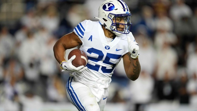 Sep 18, 2021; Provo, Utah, USA; BYU Cougars running back Tyler Allgeier (25) carries the ball in the first quarter against the Arizona State Sun Devils at LaVell Edwards Stadium. Mandatory Credit: Kirby Lee-USA TODAY Sports