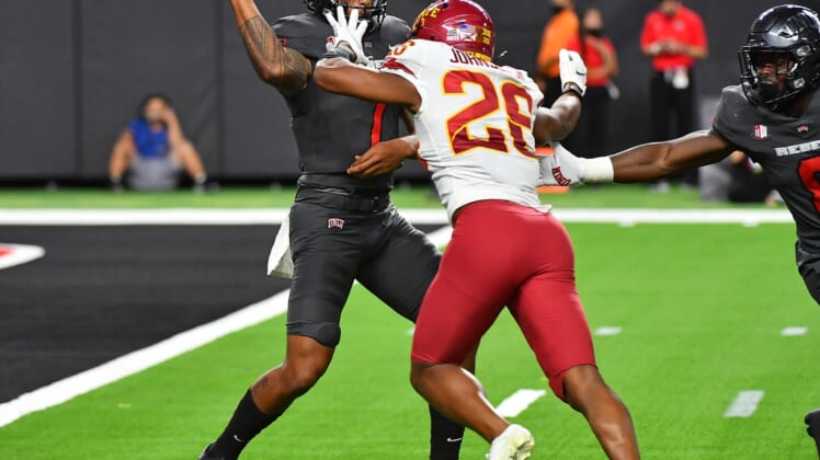 Sep 18, 2021; Paradise, Nevada, USA;  UNLV Rebels quarterback Cameron Friel (7) is pressured by Iowa State Cyclones defensive back Anthony Johnson Jr. (26) during the second quarter at Allegiant Stadium. Mandatory Credit: Stephen R. Sylvanie-USA TODAY Sports