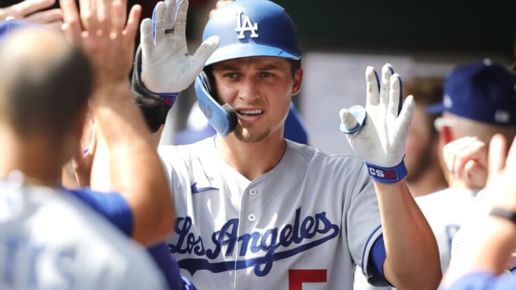 Sep 19, 2021; Cincinnati, Ohio, USA; Los Angeles Dodgers shortstop Corey Seager (5) celebrates in the dugout after hitting a two-run home run against the Cincinnati Reds during the third inning at Great American Ball Park. Mandatory Credit: David Kohl-USA TODAY Sports