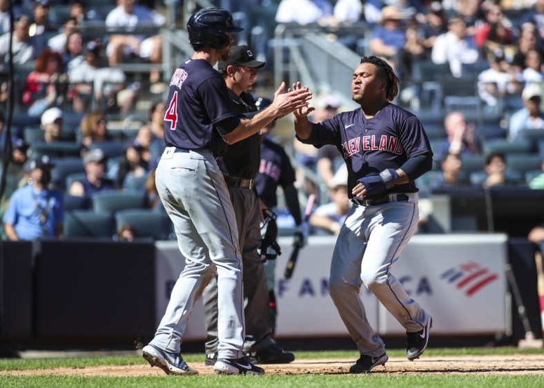 Sep 19, 2021; Bronx, New York, USA;  Cleveland Indians designated hitter Jose Ramirez (11) is greeted by center fielder Bradley Zimmer (4) after scoring in the third inning against the New York Yankees at Yankee Stadium. Mandatory Credit: Wendell Cruz-USA TODAY Sports
