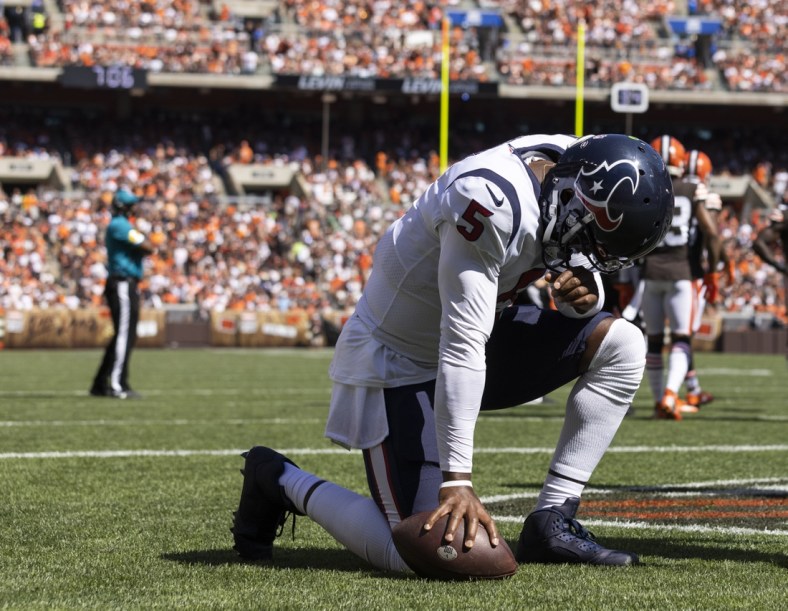 Sep 19, 2021; Cleveland, Ohio, USA; Houston Texans quarterback Tyrod Taylor (5) kneels in the end zone following his touchdown run against the Cleveland Browns during the second quarter at FirstEnergy Stadium. Mandatory Credit: Scott Galvin-USA TODAY Sports
