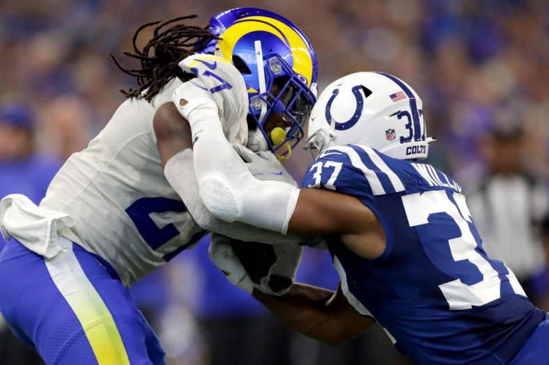 Indianapolis Colts safety Khari Willis (37) works to bring down Los Angeles Rams running back Darrell Henderson Jr. (27) on Sunday, Sept. 19, 2021, during a game against the Los Angeles Rams at Lucas Oil Stadium in Indianapolis.