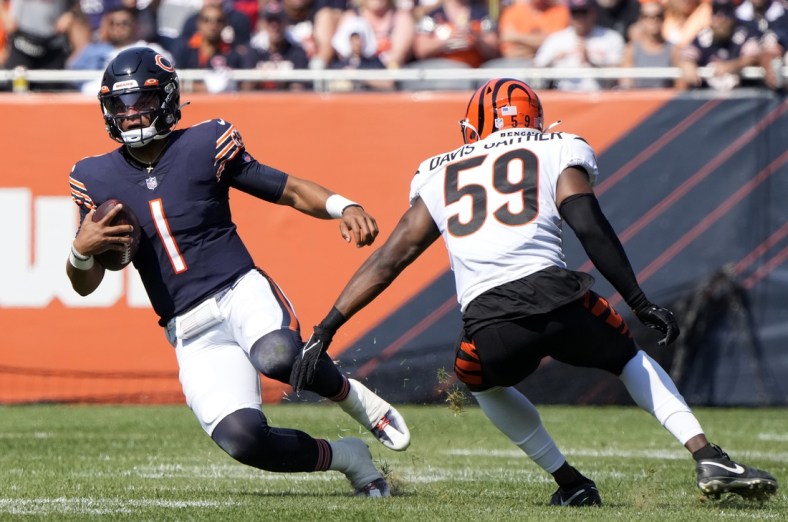 Sep 19, 2021; Chicago, Illinois, USA; Chicago Bears quarterback Justin Fields (1) rushes the ball against Cincinnati Bengals linebacker Akeem Davis-Gaither (59) during the second half at Soldier Field. Mandatory Credit: Mike Dinovo-USA TODAY Sports