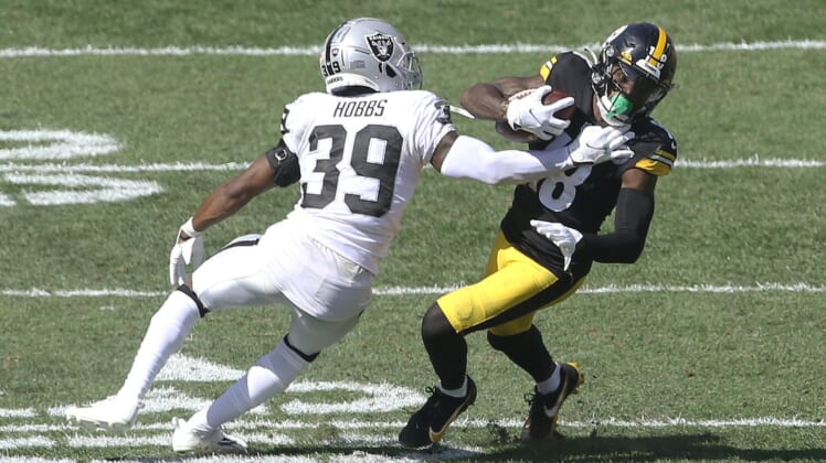 Sep 19, 2021; Pittsburgh, Pennsylvania, USA;  Las Vegas Raiders cornerback Nate Hobbs (39) defends Pittsburgh Steelers wide receiver Diontae Johnson (18) after a catch during the third quarter at Heinz Field. Las Vegas won 26-17. Mandatory Credit: Charles LeClaire-USA TODAY Sports