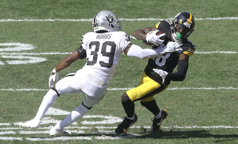 Sep 19, 2021; Pittsburgh, Pennsylvania, USA;  Las Vegas Raiders cornerback Nate Hobbs (39) defends Pittsburgh Steelers wide receiver Diontae Johnson (18) after a catch during the third quarter at Heinz Field. Las Vegas won 26-17. Mandatory Credit: Charles LeClaire-USA TODAY Sports