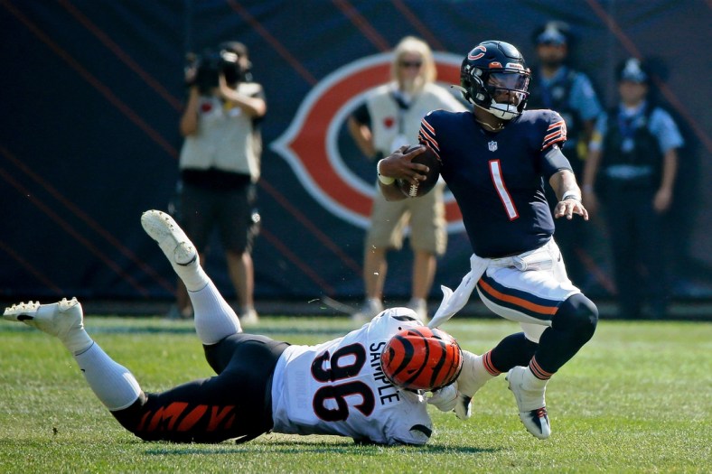 Sep 19, 2021; Chicago, Illinois, USA; Chicago Bears quarterback Justin Fields (1) gets tripped up by Cincinnati Bengals defensive end Cameron Sample (96) during the fourth quarter at Soldier Field. Mandatory Credit: Jon Durr-USA TODAY Sports