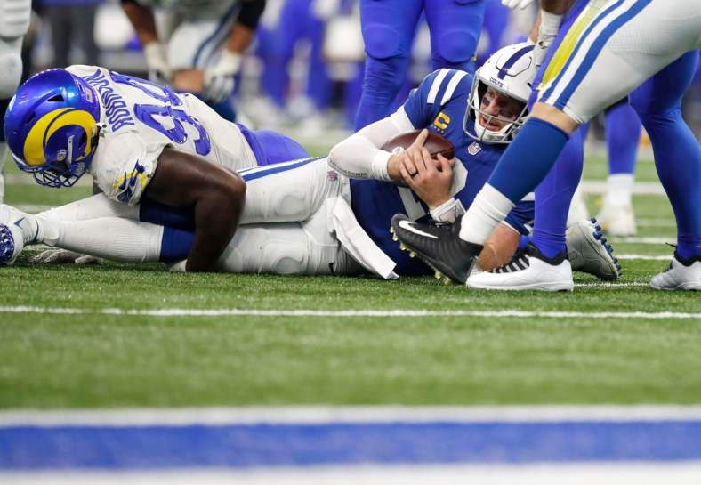 Indianapolis Colts quarterback Carson Wentz (2) is tackled close to the end zone during the second half of an Indianapolis Colts game against the Los Angeles Rams on Sunday, Sept. 19, 2021, at Lucas Oil Stadium. The Rams won 27-24.