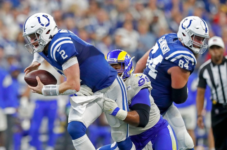 Indianapolis Colts quarterback Carson Wentz (2) keeps hold of the ball during the second half of an Indianapolis Colts game against the Los Angeles Rams on Sunday, Sept. 19, 2021, at Lucas Oil Stadium. The Rams won 27-24.