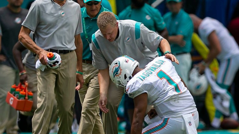 Miami Dolphins Miami Dolphins quarterback Tua Tagovailoa (1), falls to the ground as he ties to leave the field after being sacked by Buffalo Bills offensive tackle Daryl Williams (75) during first quarter action of their NFL game at Hard Rock Stadium Sunday in Miami Gardens. Tagovailoa did not return to action. BILL INGRAM/ Palm Beach PostDolphins V Bills 02