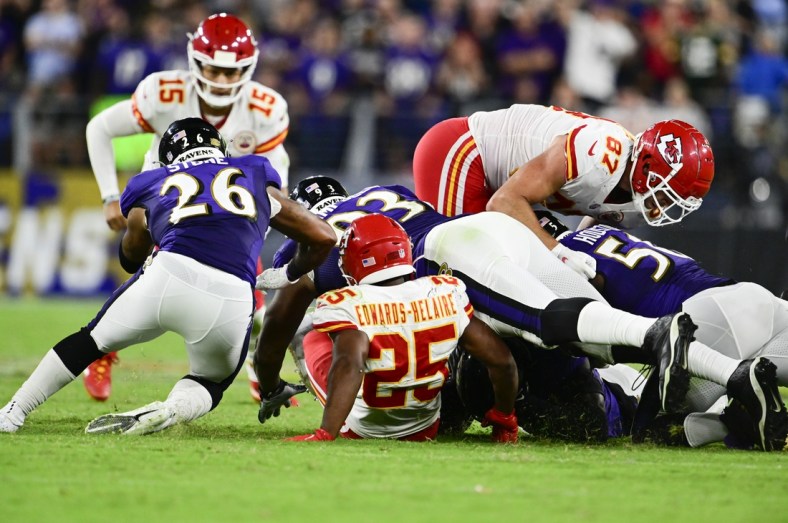 Sep 19, 2021; Baltimore, Maryland, USA;  Kansas City Chiefs running back Clyde Edwards-Helaire (25) fumbles as Baltimore Ravens defender se recovers during the fourth quarter at M&T Bank Stadium. Mandatory Credit: Tommy Gilligan-USA TODAY Sports