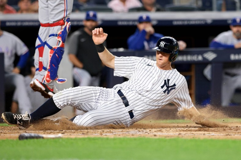Sep 20, 2021; Bronx, New York, USA; New York Yankees second baseman DJ LeMahieu (26) scores on a RBI single by Aaron Judge (not pictured) against the Texas Rangers during the third inning at Yankee Stadium. Mandatory Credit: Vincent Carchietta-USA TODAY Sports