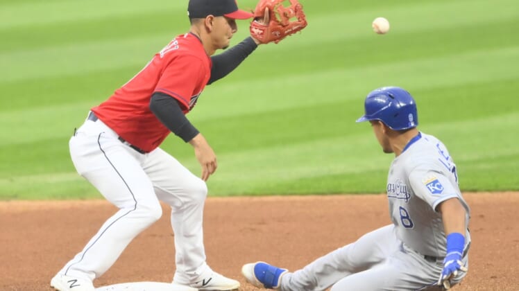 Sep 20, 2021; Cleveland, Ohio, USA; Kansas City Royals shortstop Nicky Lopez (8) slides safely for a double beside Cleveland Indians shortstop Andres Gimenez (0) in the first inning at Progressive Field. Mandatory Credit: David Richard-USA TODAY Sports