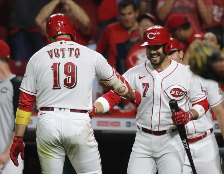 Sep 20, 2021; Cincinnati, Ohio, USA; Cincinnati Reds first baseman Joey Votto (19) reacts with third baseman Eugenio Suarez (7) after hitting a solo home run against the Pittsburgh Pirates during the fifth inning at Great American Ball Park. Mandatory Credit: David Kohl-USA TODAY Sports