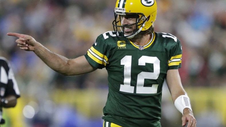 Sep 20, 2021; Green Bay, WIsconsin, USA; Green Bay Packers quarterback Aaron Rodgers (12) celebrates after a pass completion to wide receiver Davante Adams (not pictured) against the Detroit Lions at Lambeau Field. Mandatory Credit: Dan Powers/Appleton Post-Crescent via USA TODAY NETWORK