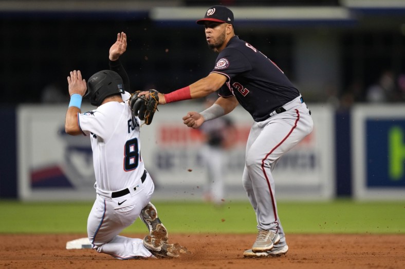 Sep 21, 2021; Miami, Florida, USA; Washington Nationals second baseman Luis Garcia (2) tags out Miami Marlins catcher Nick Fortes (84) while turning a double play in the 2nd inning at loanDepot park. Mandatory Credit: Jasen Vinlove-USA TODAY Sports