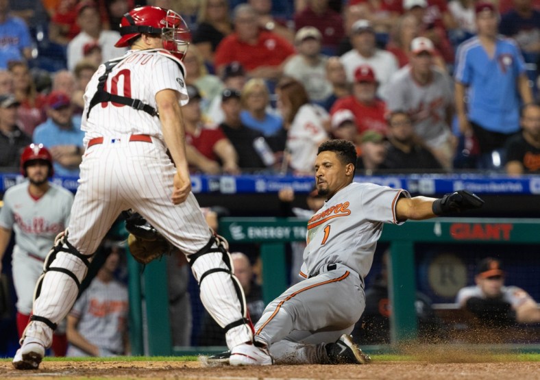 Sep 21, 2021; Philadelphia, Pennsylvania, USA; Baltimore Orioles shortstop Richie Martin (1) slides home safely past Philadelphia Phillies catcher J.T. Realmuto (10) during the fourth inning at Citizens Bank Park. Mandatory Credit: Bill Streicher-USA TODAY Sports