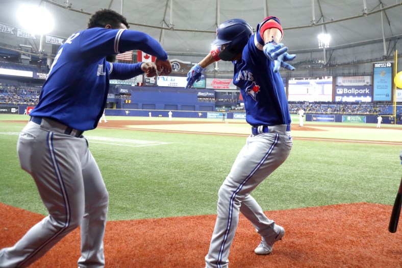 Sep 21, 2021; St. Petersburg, Florida, USA; Toronto Blue Jays left fielder Lourdes Gurriel Jr. (right) celebrates with right fielder Teoscar Hernandez (left) after hitting a home run against the Tampa Bay Rays during the fifth inning at Tropicana Field. Mandatory Credit: Kim Klement-USA TODAY Sports