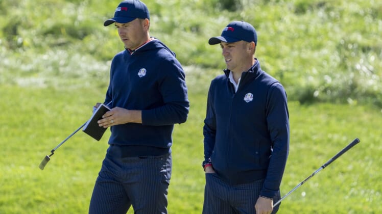September 22, 2021; Haven, Wisconsin, USA; Team USA players Jordan Spieth (left) and Justin Thomas (right) look on at the 18th green during a practice round for the 43rd Ryder Cup golf competition at Whistling Straits. Mandatory Credit: Kyle Terada-USA TODAY Sports