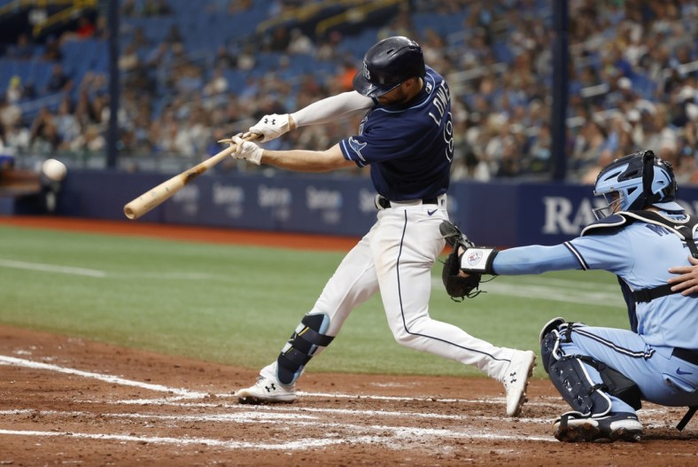 Sep 22, 2021; St. Petersburg, Florida, USA; Tampa Bay Rays second baseman Brandon Lowe (8) singles during the third inning against the Toronto Blue Jays at Tropicana Field. Mandatory Credit: Kim Klement-USA TODAY Sports