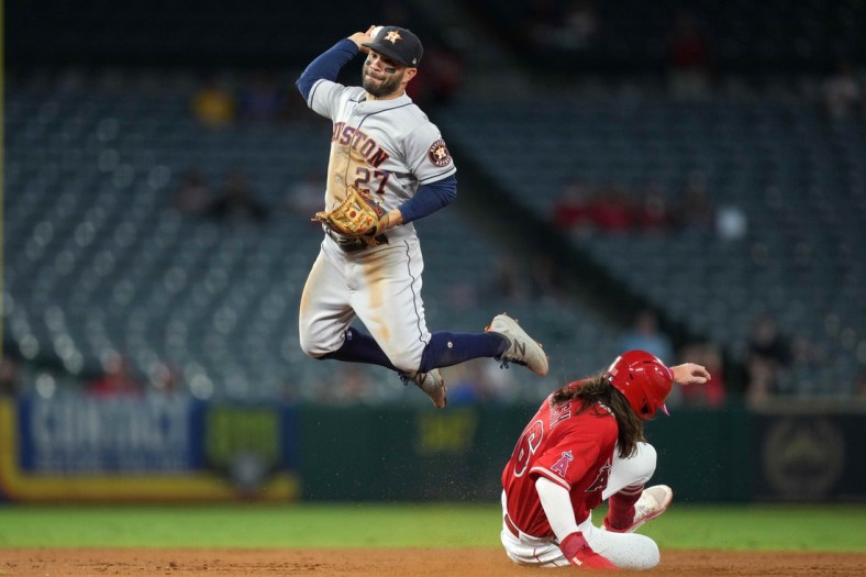 Sep 22, 2021; Anaheim, California, USA; Houston Astros second baseman Jose Altuve (27) forces out Los Angeles Angels center fielder Brandon Marsh (16) at second base in the second inning at Angel Stadium. Mandatory Credit: Kirby Lee-USA TODAY Sports