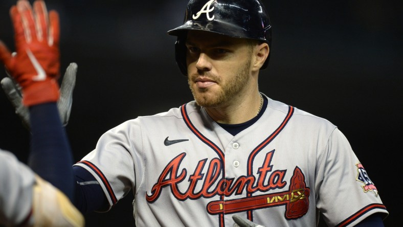 Sep 22, 2021; Phoenix, Arizona, USA; Atlanta Braves first baseman Freddie Freeman (5) celebrates after hitting a home run against the Arizona Diamondbacks during the ninth inning at Chase Field. Mandatory Credit: Joe Camporeale-USA TODAY Sports