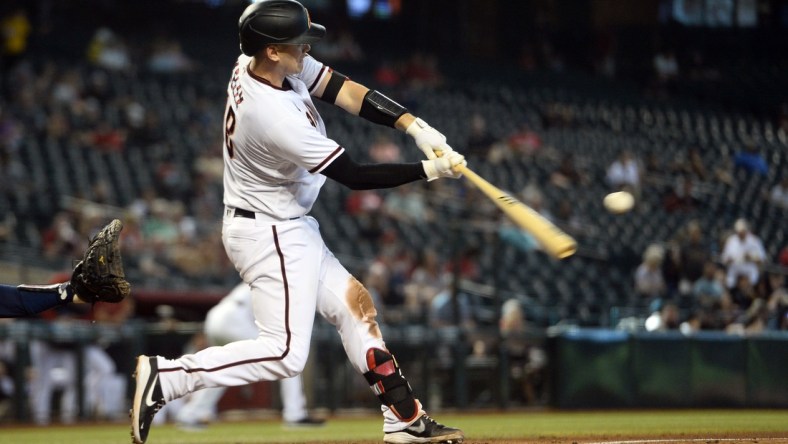 Sep 23, 2021; Phoenix, Arizona, USA; Arizona Diamondbacks catcher Carson Kelly (18) hits a three run home run against the Atlanta Braves during the seventh inning at Chase Field. Mandatory Credit: Joe Camporeale-USA TODAY Sports