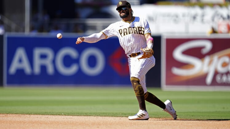 Sep 23, 2021; San Diego, California, USA;  San Diego Padres shortstop Fernando Tatis Jr. (23) throws out San Francisco Giants right fielder LaMonte Wade Jr. (not pictured) at first base during the fourth inning at Petco Park. Mandatory Credit: Ray Acevedo-USA TODAY Sports