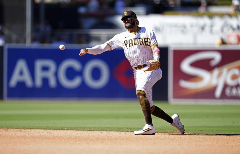 Sep 23, 2021; San Diego, California, USA;  San Diego Padres shortstop Fernando Tatis Jr. (23) throws out San Francisco Giants right fielder LaMonte Wade Jr. (not pictured) at first base during the fourth inning at Petco Park. Mandatory Credit: Ray Acevedo-USA TODAY Sports