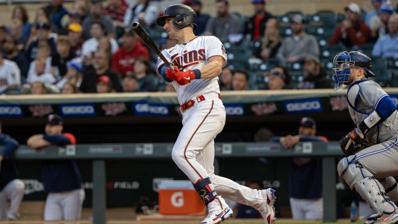 Sep 23, 2021; Minneapolis, Minnesota, USA; Minnesota Twins catcher Mitch Garver (8) hits a single during the first inning against the Toronto Blue Jays at Target Field. Mandatory Credit: Jordan Johnson-USA TODAY Sports