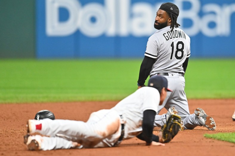 Sep 23, 2021; Cleveland, Ohio, USA; Chicago White Sox left fielder Brian Goodwin (18) looks back at Cleveland Indians second baseman Yu Chang (2) after Chang tagged Goodwin out during a rundown in the fourth inning at Progressive Field. Mandatory Credit: Ken Blaze-USA TODAY Sports