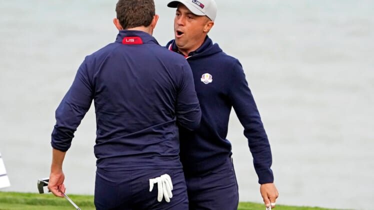 Sep 24, 2021; Haven, Wisconsin, USA; Team USA player Justin Thomas reacts with Team USA player Patrick Cantlay after making his putt on the 16th green during day one foursome matches for the 43rd Ryder Cup golf competition at Whistling Straits. Mandatory Credit: Kyle Terada-USA TODAY Sports