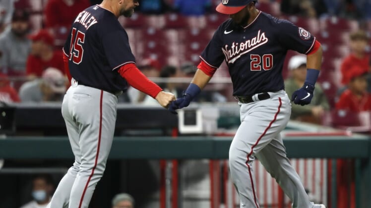 Sep 24, 2021; Cincinnati, Ohio, USA; Washington Nationals catcher Keibert Ruiz (20) celebrates with third base coach Bob Henley (15) after hitting a solo home run against the Cincinnati Reds during the second inning at Great American Ball Park. Mandatory Credit: David Kohl-USA TODAY Sports
