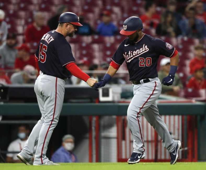 Sep 24, 2021; Cincinnati, Ohio, USA; Washington Nationals catcher Keibert Ruiz (20) celebrates with third base coach Bob Henley (15) after hitting a solo home run against the Cincinnati Reds during the second inning at Great American Ball Park. Mandatory Credit: David Kohl-USA TODAY Sports
