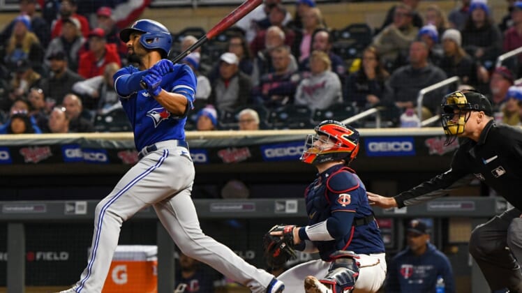 Sep 24, 2021; Minneapolis, Minnesota, USA; Toronto Blue Jays infielder Marcus Semien (10) hits a double off of Minnesota Twins starting pitcher Bailey Ober (82) during the first inning at Target Field. Mandatory Credit: Nick Wosika-USA TODAY Sports