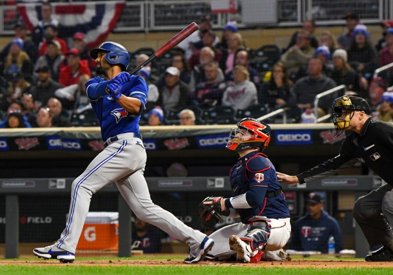 Sep 24, 2021; Minneapolis, Minnesota, USA; Toronto Blue Jays infielder Marcus Semien (10) hits a double off of Minnesota Twins starting pitcher Bailey Ober (82) during the first inning at Target Field. Mandatory Credit: Nick Wosika-USA TODAY Sports
