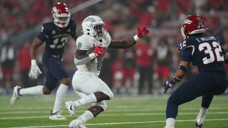 Sep 24, 2021; Fresno, California, USA; UNLV Rebels outside linebacker Kylan Wilborn (8) runs the ball against the Fresno State Bulldogs in the first quarter at Bulldog Stadium. Mandatory Credit: Cary Edmondson-USA TODAY Sports