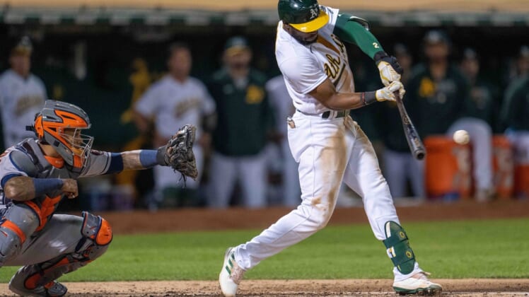 Sep 24, 2021; Oakland, California, USA;  Oakland Athletics center fielder Starling Marte (2) hits a RBI single during the third inning against the Houston Astros at RingCentral Coliseum. Mandatory Credit: Neville E. Guard-USA TODAY Sports