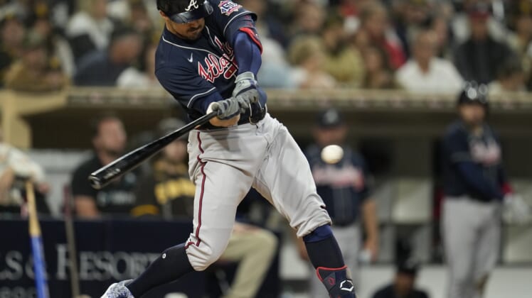 Sep 24, 2021; San Diego, California, USA;  Atlanta Braves left fielder Adam Duvall (14) hits an hits an RBI single against the San Diego Padres during the sixth inning at Petco Park. Mandatory Credit: Ray Acevedo-USA TODAY Sports