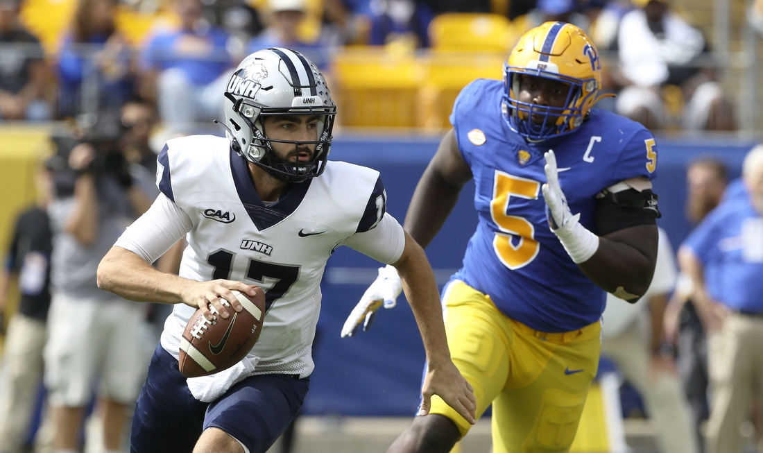 Sep 25, 2021; Pittsburgh, Pennsylvania, USA;  New Hampshire Wildcats quarterback Bret Edwards (17) scrambles with the ball as Pittsburgh Panthers defensive lineman Deslin Alexandre (5) chases during the second quarter at Heinz Field. Mandatory Credit: Charles LeClaire-USA TODAY Sports