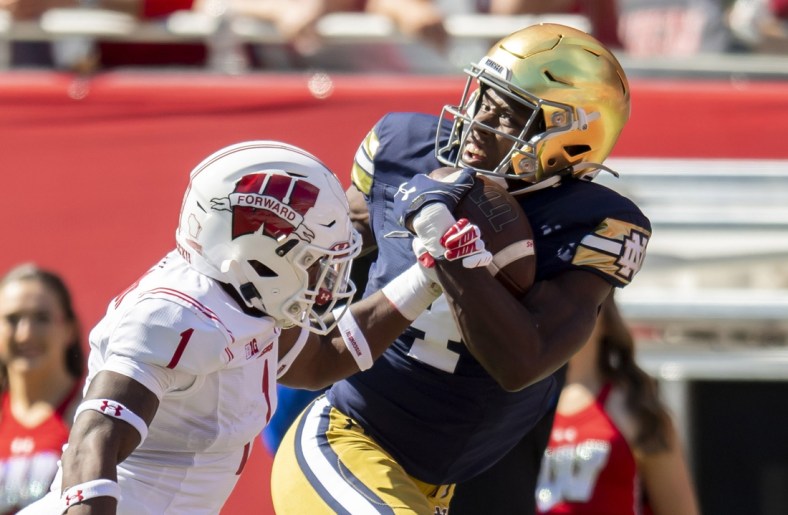 Sep 25, 2021; Chicago, Illinois, USA; Notre Dame Fighting Irish wide receiver Kevin Austin Jr. (4) receives a pass for a touchdown against Wisconsin Badgers cornerback Faion Hicks (1) during the first half at Soldier Field. Mandatory Credit: Patrick Gorski-USA TODAY Sports