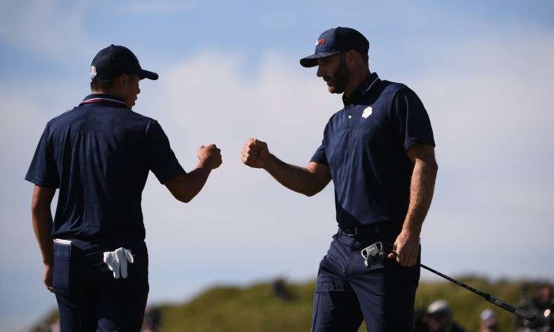 Sep 25, 2021; Haven, Wisconsin, USA; Team USA player Collin Morikawa and Team USA player Dustin Johnson bump fist after Joshnson's putt during day two foursomes rounds for the 43rd Ryder Cup golf competition at Whistling Straits. Mandatory Credit: Orlando Ramirez-USA TODAY Sports