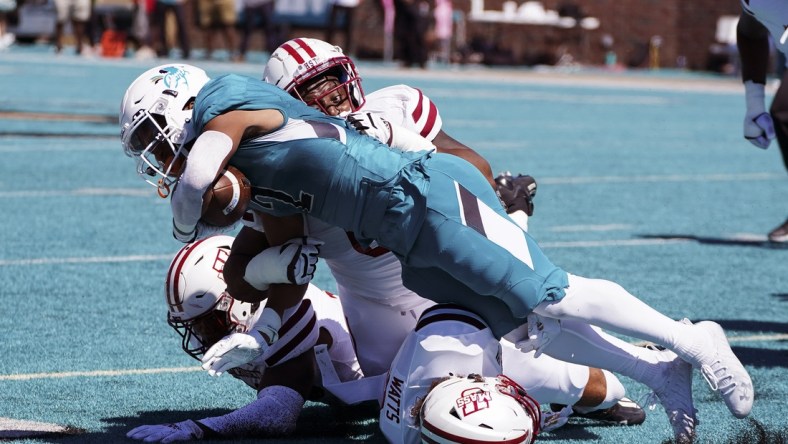 Sep 25, 2021; Conway, South Carolina, USA; Coastal Carolina Chanticleers running back Reese White (2) is tackled by the Massachusetts Minutemen in the NCAA football game of Massachusetts and Coastal Carolina at Brooks Stadium. Mandatory Credit: David Yeazell-USA TODAY Sports