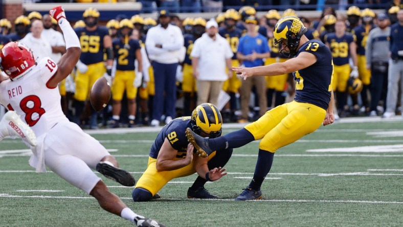 Sep 25, 2021; Ann Arbor, Michigan, USA;  Michigan Wolverines place kicker Jake Moody (13) kicks a field goal out of the hold by Michigan Wolverines punter Brad Robbins (91) in first half against the Rutgers Scarlet Knights at Michigan Stadium. Mandatory Credit: Rick Osentoski-USA TODAY Sports