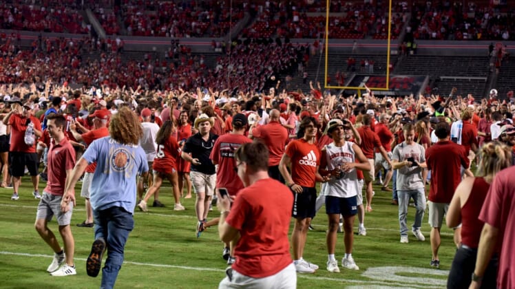 Sep 25, 2021; Raleigh, North Carolina, USA; North Carolina State Wolfpack fans storm the field after a win against the Clemson Tigers at Carter-Finley Stadium. Mandatory Credit: Rob Kinnan-USA TODAY Sports