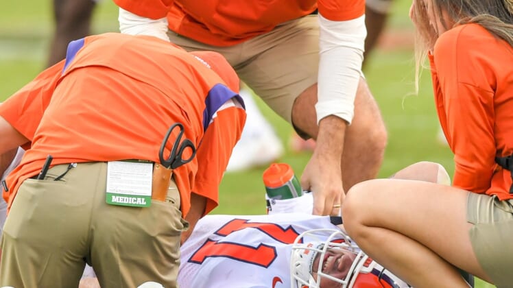 Clemson defensive lineman Bryan Bresee (11) is looked at by trainers after being injured during the third quarter at Carter-Finley Stadium in Raleigh, N.C., September 25, 2021.  The Tigers lost 27-21 in two overtimes game at Carter-Finley Stadium in Raleigh, N.C., September 25, 2021.Ncaa Football Clemson At Nc State