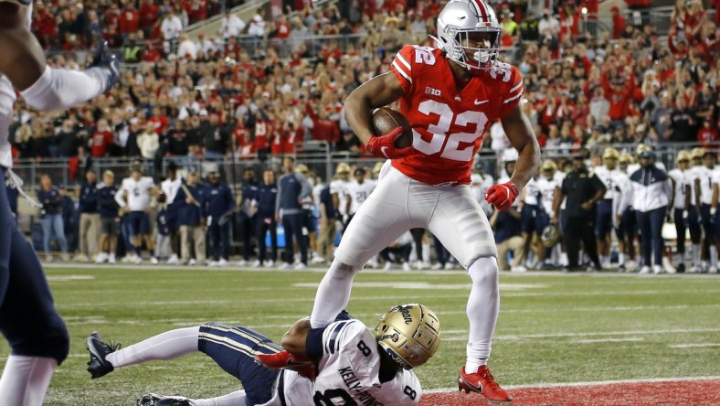 Sep 25, 2021; Columbus, Ohio, USA; Ohio State Buckeyes running back TreVeyon Henderson (32) runs in the touchdown over Akron Zips safety Jaylen Kelly-Powell (8)during the first quarter at Ohio Stadium. Mandatory Credit: Joseph Maiorana-USA TODAY Sports