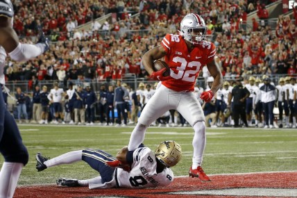 Sep 25, 2021; Columbus, Ohio, USA; Ohio State Buckeyes running back TreVeyon Henderson (32) runs in the touchdown over Akron Zips safety Jaylen Kelly-Powell (8)during the first quarter at Ohio Stadium. Mandatory Credit: Joseph Maiorana-USA TODAY Sports