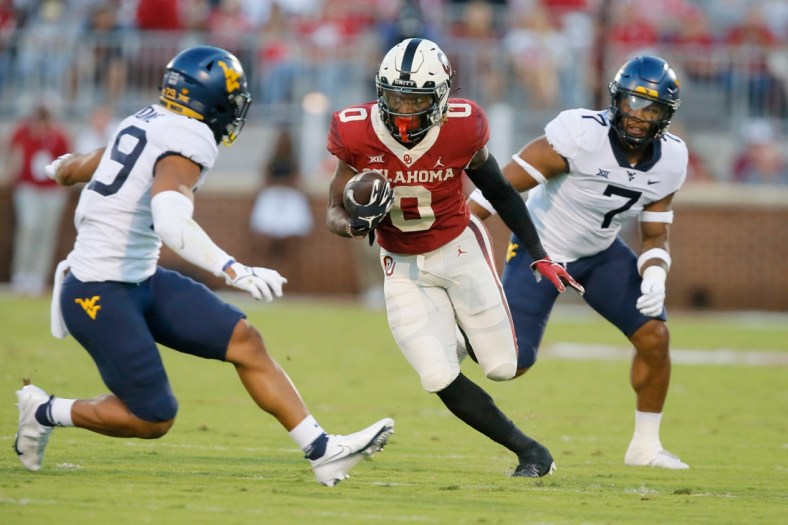 Oklahoma's Eric Gray (0) runs after  reception during a college football game between the University of Oklahoma Sooners (OU) and the West Virginia Mountaineers at Gaylord Family-Oklahoma Memorial Stadium in Norman, Okla., Saturday, Sept. 25, 2021.

Lx10761