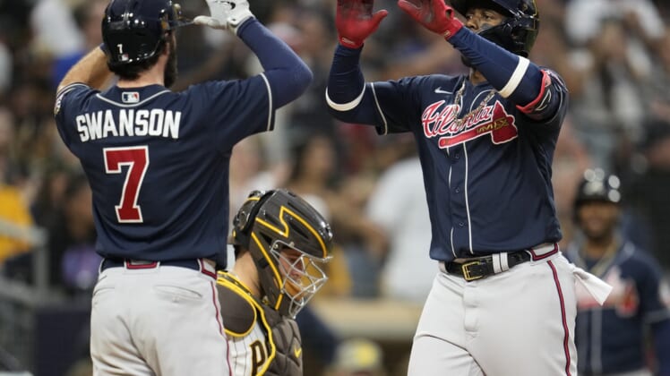 Sep 25, 2021; San Diego, California, USA;  Atlanta Braves right fielder Jorge Soler (12) celebrates his two run home run against the San Diego Padres with shortstop Dansby Swanson (left) during the sixth inning at Petco Park. Mandatory Credit: Ray Acevedo-USA TODAY Sports