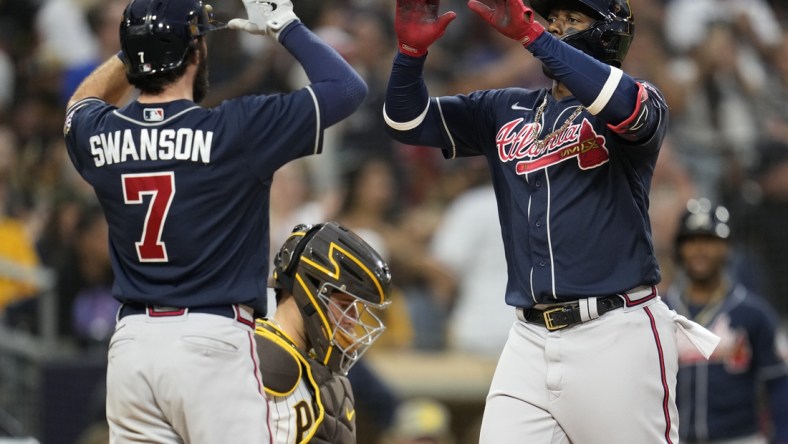 Sep 25, 2021; San Diego, California, USA;  Atlanta Braves right fielder Jorge Soler (12) celebrates his two run home run against the San Diego Padres with shortstop Dansby Swanson (left) during the sixth inning at Petco Park. Mandatory Credit: Ray Acevedo-USA TODAY Sports